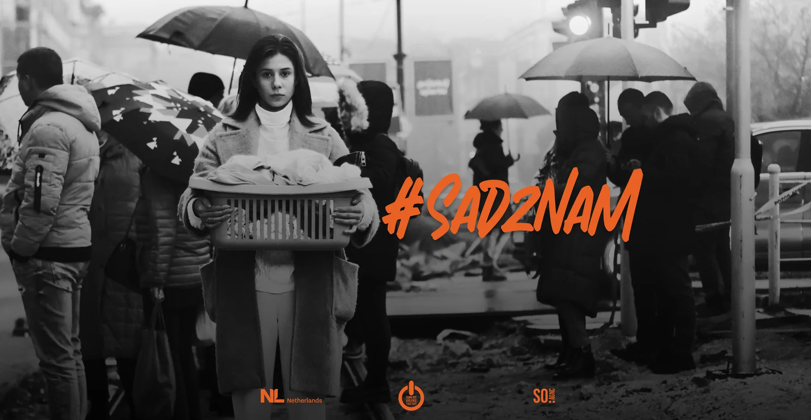 Campaign artwork in black and white: a woman with a basket among people under umbrellas, the #SadZnam lettering at the right.