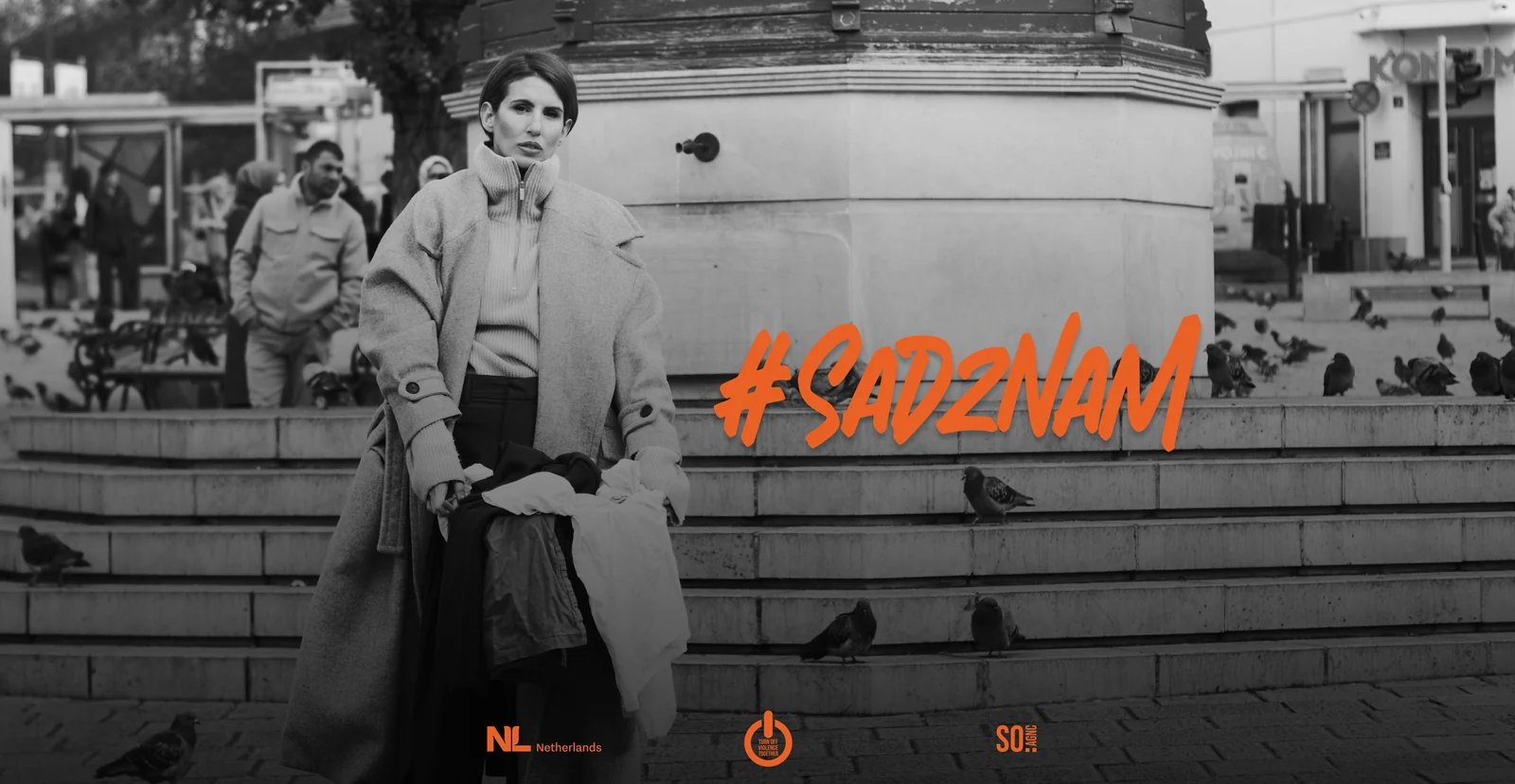 Campaign artwork in black and white: a woman on steps among pigeons, the #SadZnam lettering across the picture.
