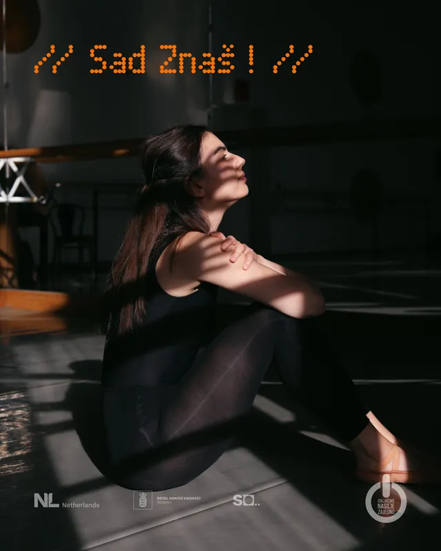 Campaign poster: a woman sits in hard light, her shadow falling across the wall behind her.